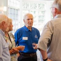 Jim and Chris Scott talking with two men at event